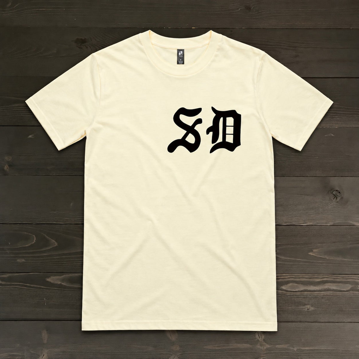 Men Black Old English SD on Creme Tee | TM-030
